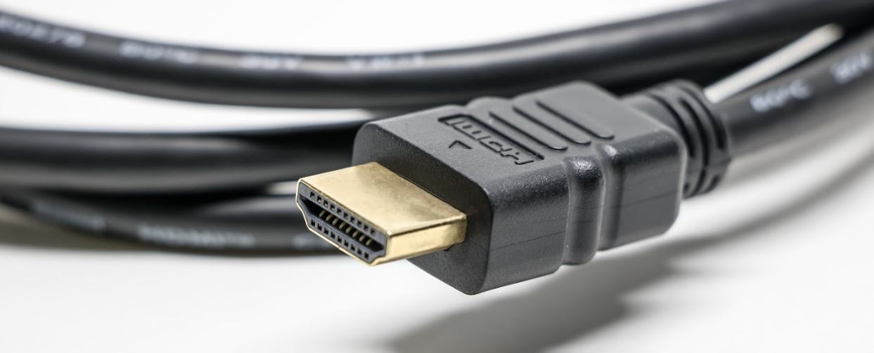 Photo of a coiled HDMI cable focused on the plug itself.